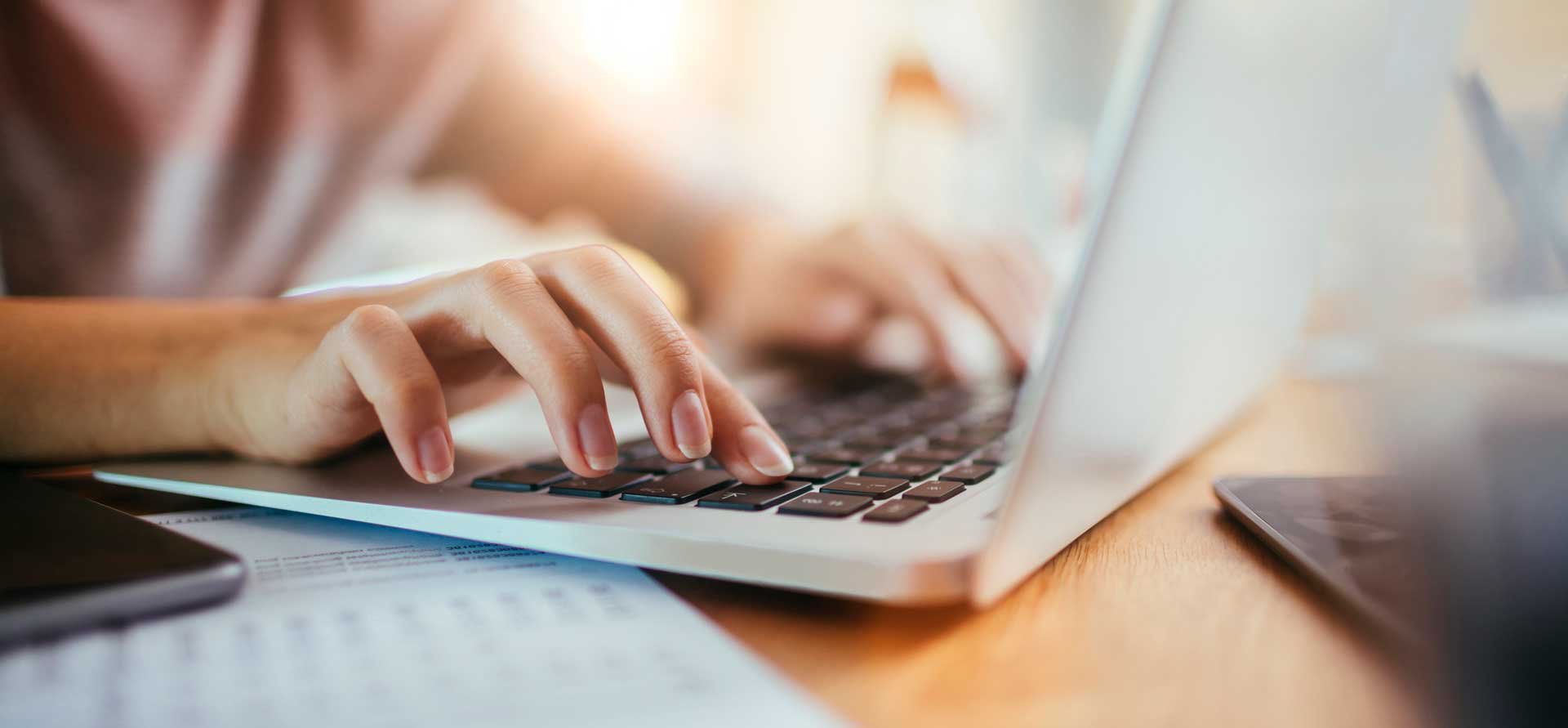 hands on laptop keyboard