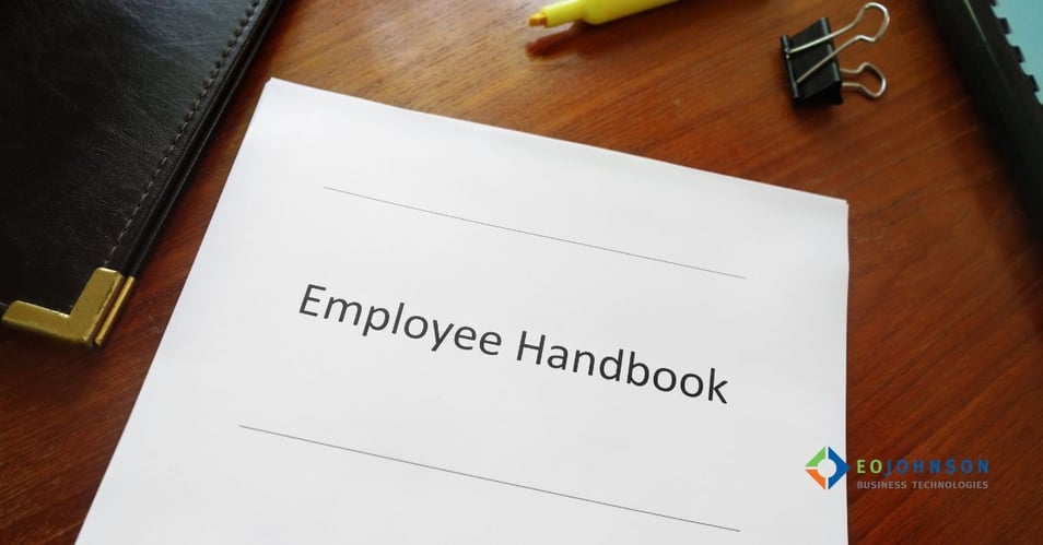 an image of a paper employee manual on a desk