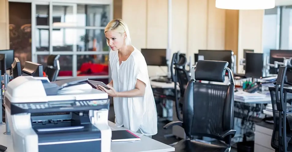 a professional diagnosing printing challenges in an office setting