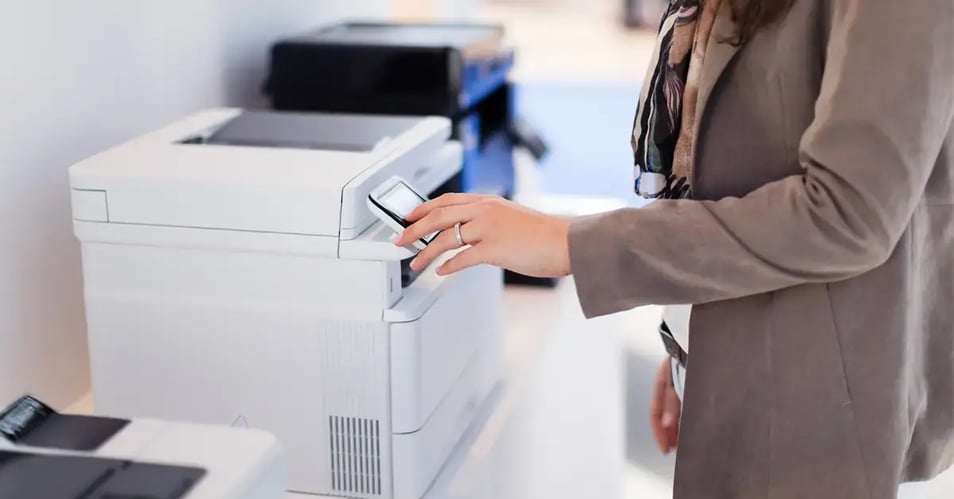a community bank employee using a printer