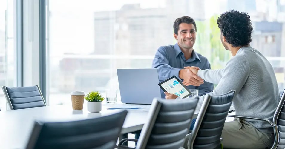 image of two professionals reviewing an RFP at a conference table