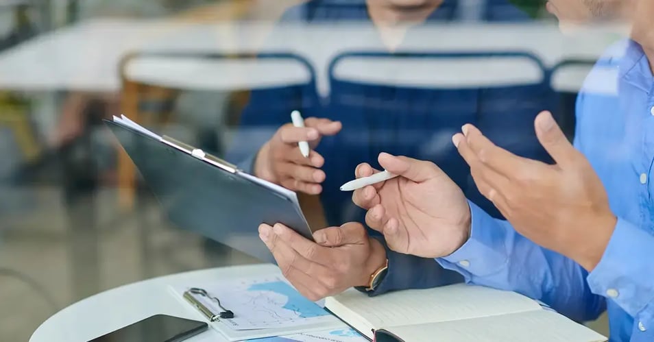 an image of two professionals evaluating managed print service providers