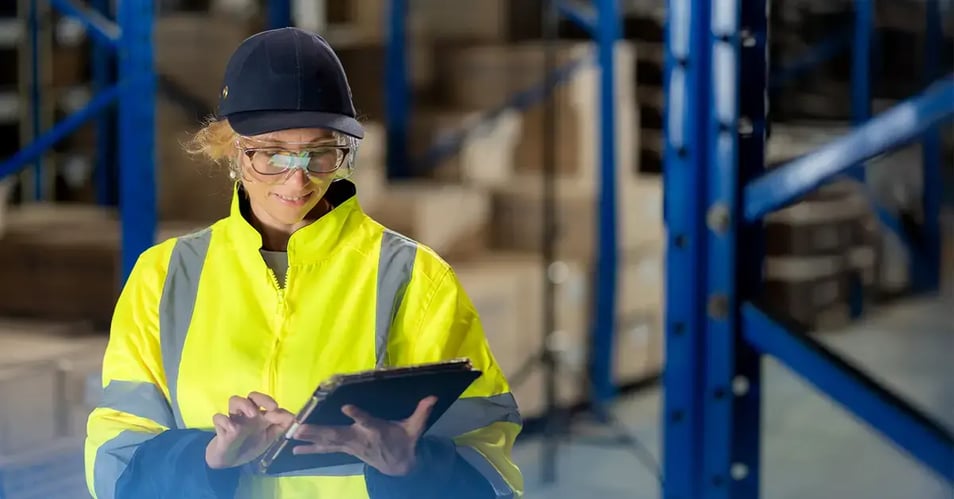 an image of a warehouse employee accessing a document within seconds on a tablet thanks to bulk document scanning