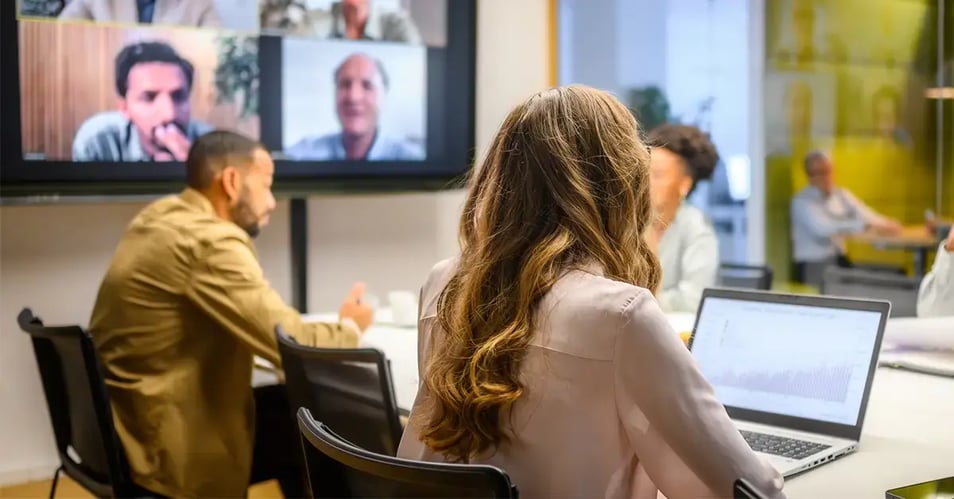 a group of people meeting in a conference room and virtually to do business process mapping