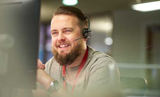 support staff on phone smiling