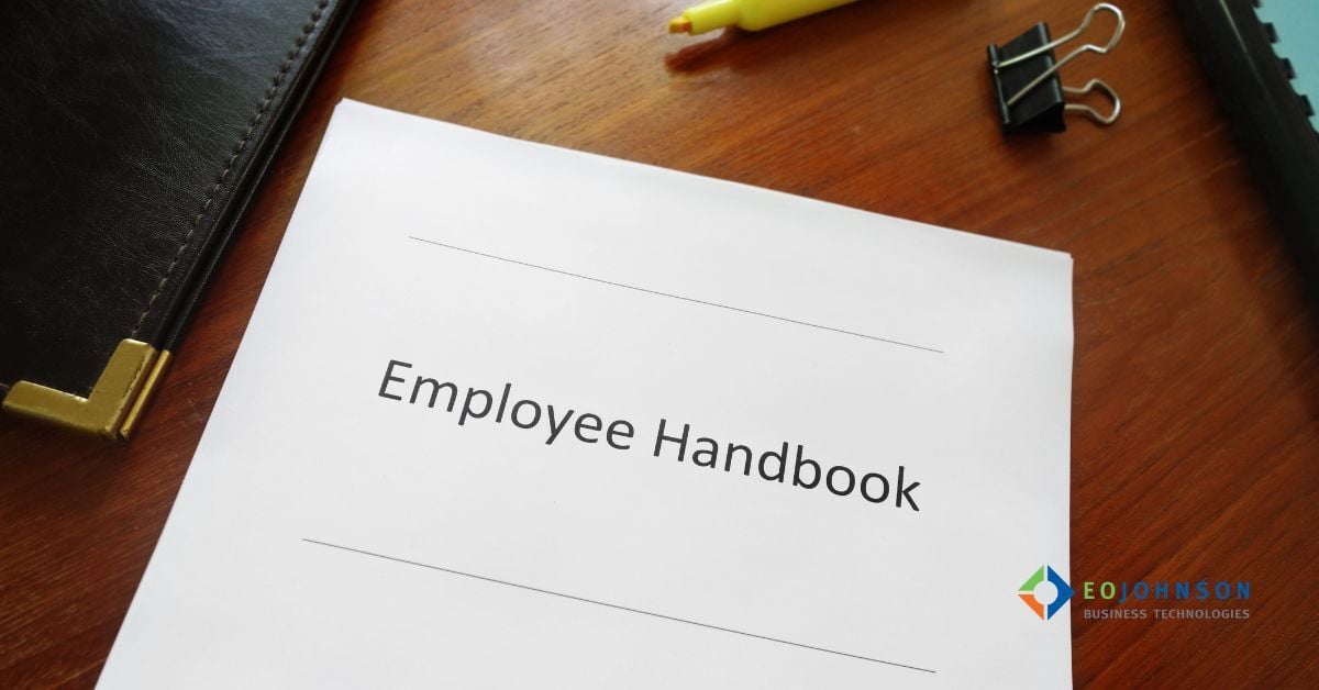 an image of a paper employee manual on a desk