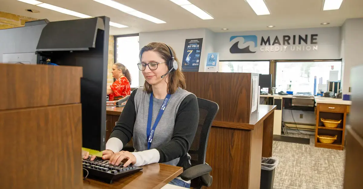 image of a bank teller working at her computer