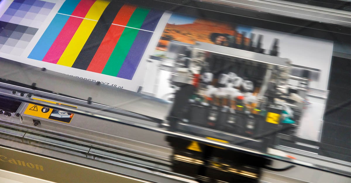 A continuous feed printer testing color in an in-plant print shop before a production print job.